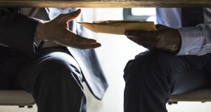 Business people sending documents under the table